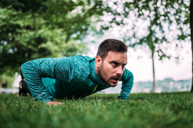 Fitness, sport, training en levensstijl concept. Push-ups doen.