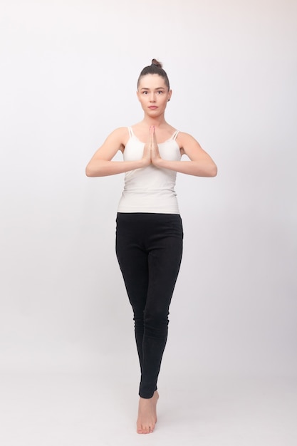 Fitness, sport, training and lifestyle concept - Young woman doing yoga exercise