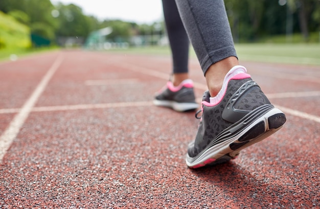 fitness, sport, training, mensen en lifestyle concept - close-up van vrouwelijke voeten die van achteren op het goede spoor lopen