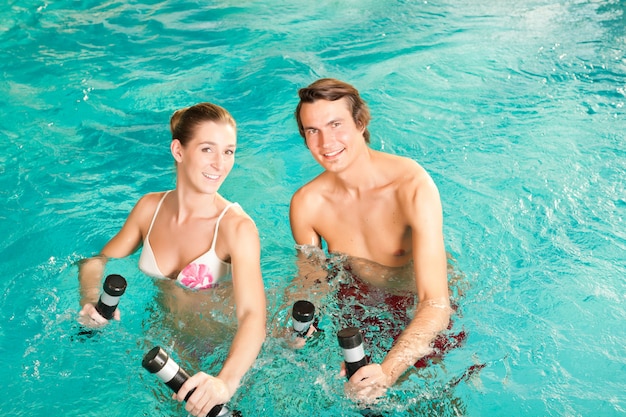 Fitness - sports and gymnastics under water in swimming pool or spa