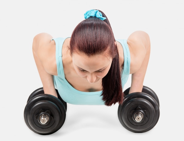 Fitness sports woman engaged in fitness with dumbbells