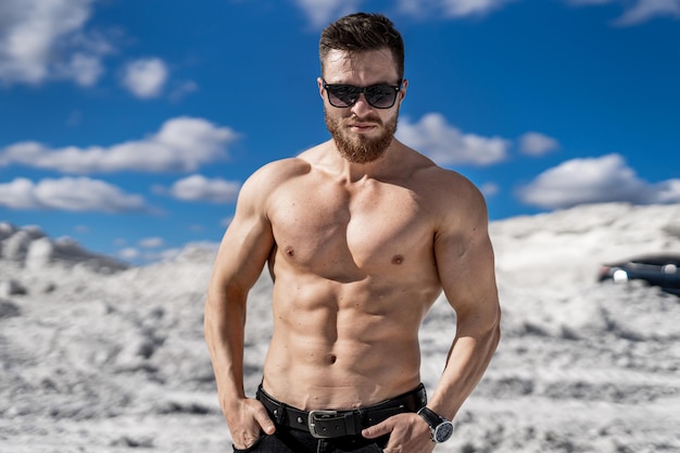 Fitness strongmen having workout outdoor in a rocky background Bodybuilders concept background  muscular bodybuilder handsome man doing exercises outdoor Half naked young man Bare torso