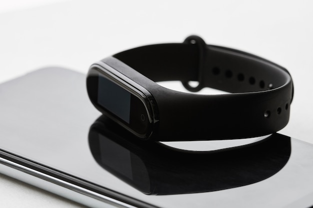 Fitness tracker lies on the smartphones