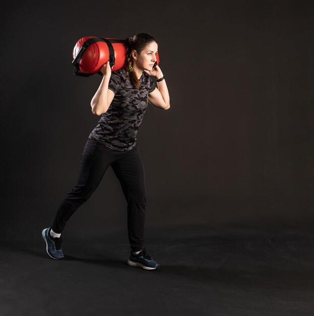 Fitness with Aqua Bag moving the lunge forward Engaged in sports on a black background Beautiful