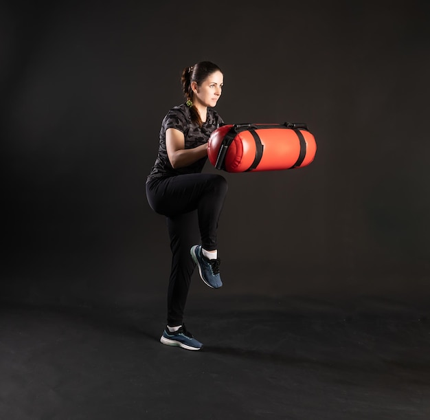 Photo fitness with aqua bag pulls a sock keeps the equipment engaged in sports on a black background