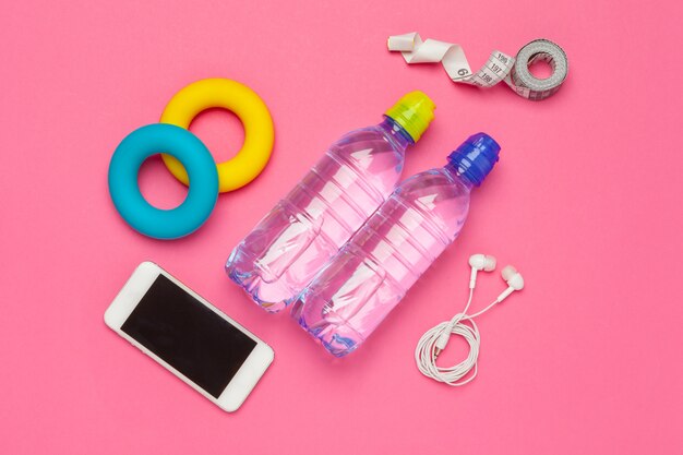 Fitness  with bottle of water, mobile phone with earphones