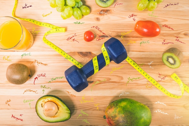 Fitness with dumbbell and genuine food with fresh fruit