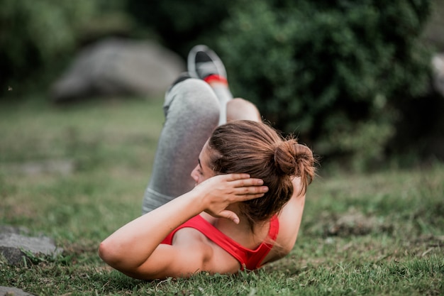 Fitness woman doing exercise outdoors in park 