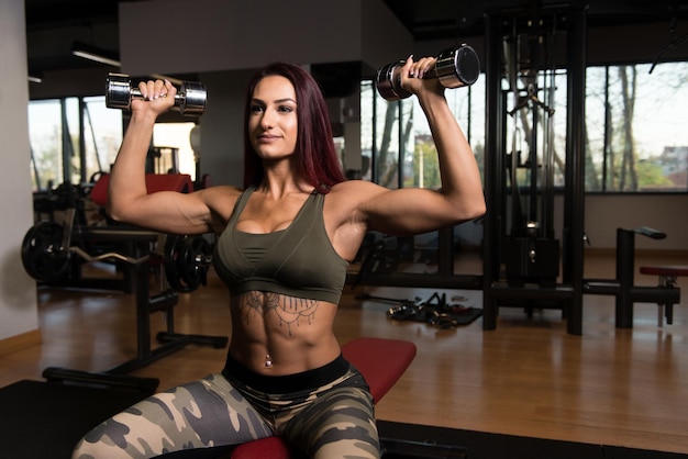 Fitness Woman Doing Exercise For Shoulders With Dumbbells