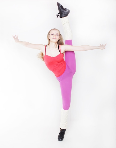 Fitness woman doing stretching exercise over white bqackground