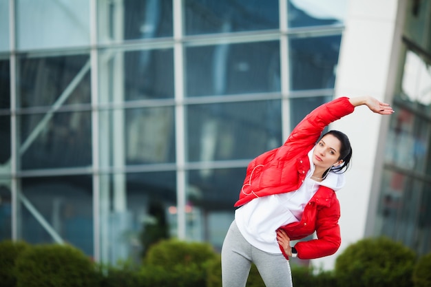 Fitness woman doing workout standing in a stadium