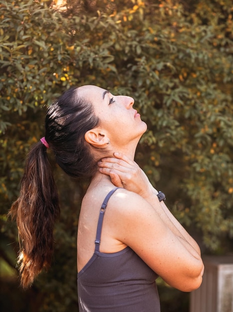 Fitness woman doing yoga exercises stretching in summer park Sport Healthy concept