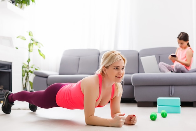 Fitness woman exercising on the floor at home