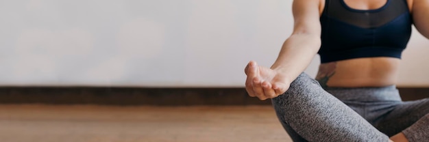 Fitness woman in a Padmasana pose