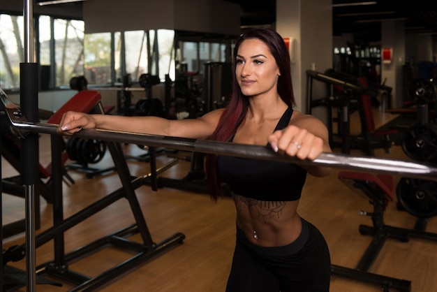 Fitness Woman Preparing To Exercising Legs Inside Gym