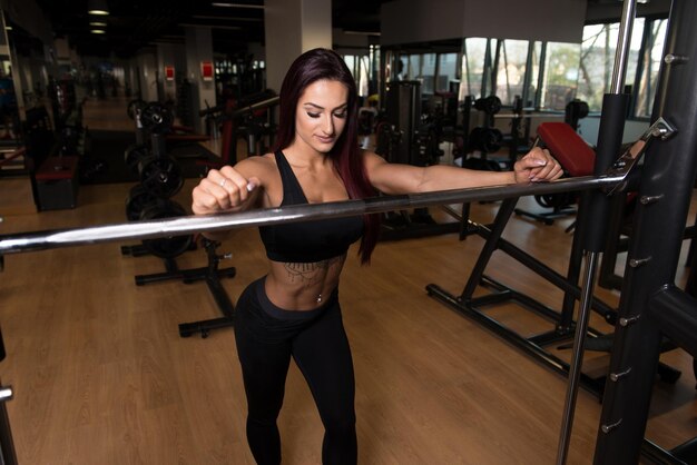 Fitness Woman Preparing To Exercising Legs Inside Gym