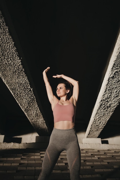 Fitness woman standing outdoors and smiling