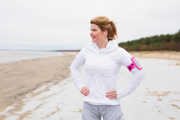 Fitness woman on th beach in winter
