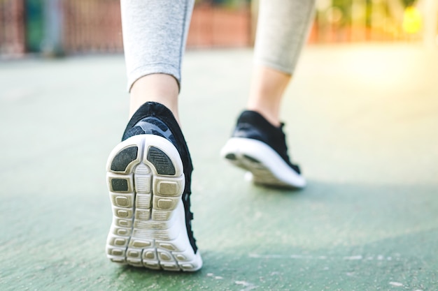 Fitness woman training and jogging in summer park