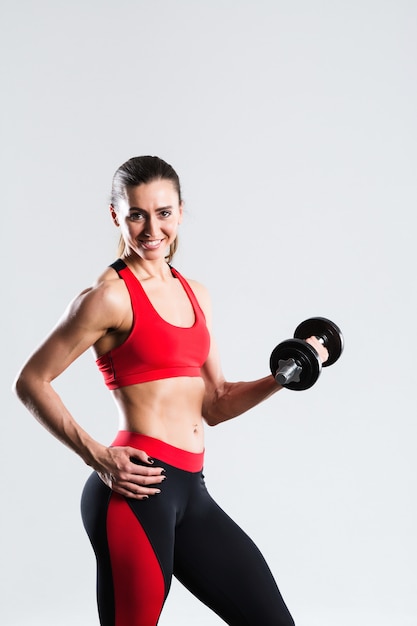 Fitness woman with dumbbells doing exercise, isolated.