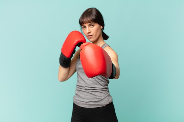 Fitness woman with red boxing gloves.