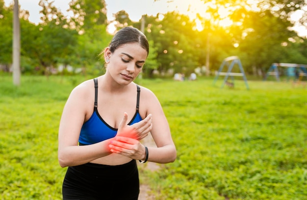 Fitness woman with wrist pain sport muscle injury concept\
runner girl with wrist pain outdoors concept of wrist pain and\
arthritis in the hands sport woman with arthritis in the wrist