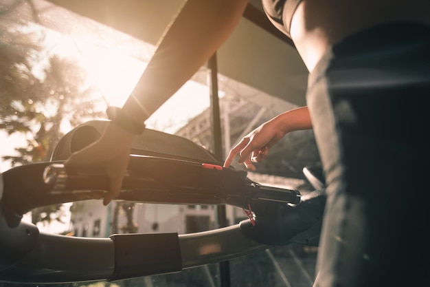 Fitness, workout, gym exercise, lifestyle and healthy concept. Close-up The hands and arms of women exercising on the treadmill in the gym for good health and strength at sunset.