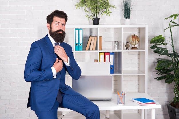 Fitting you perfectly. lawyer grooming before meeting. man is truly amazing. serious and mature boss at workplace. everything fits perfect. business is his lifestyle. confident businessman in office.