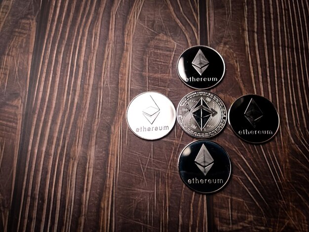 A five beautiful silver ethereum digital crypto coin on wooden table with copy space