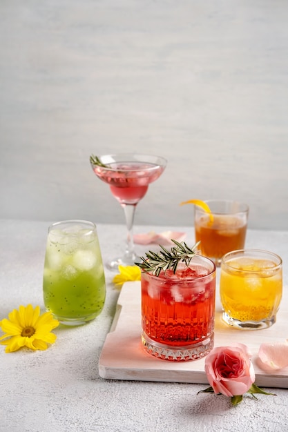 Five colorful summer cocktails in glasses on  white table. Assortment of fresh  summer drinks.