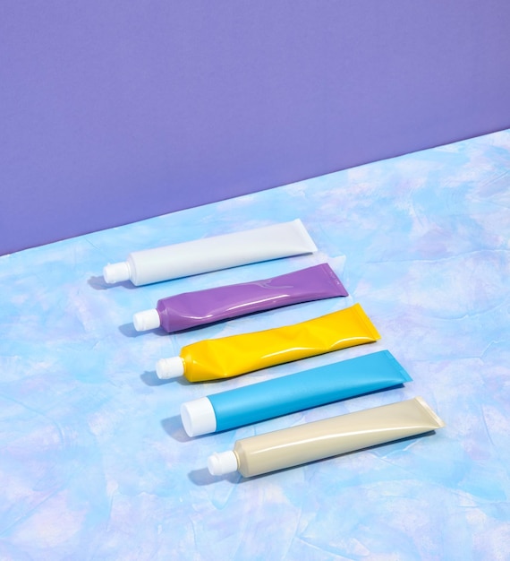 Photo five colorful tubes of toothpaste lie in a row on surface oral hygiene healthy teeth and care