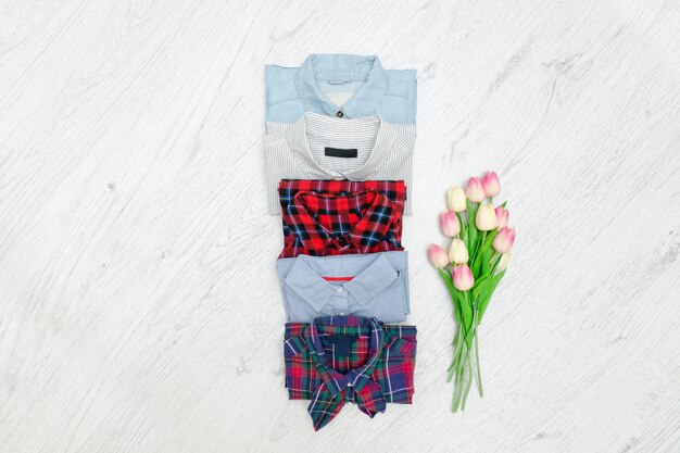 Five different shirts and a bouquet of tulips.