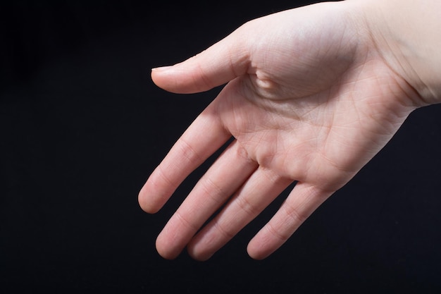 Five fingers of a human hand partly seen in view