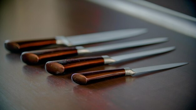 Five knives on the kitchen stand one by one