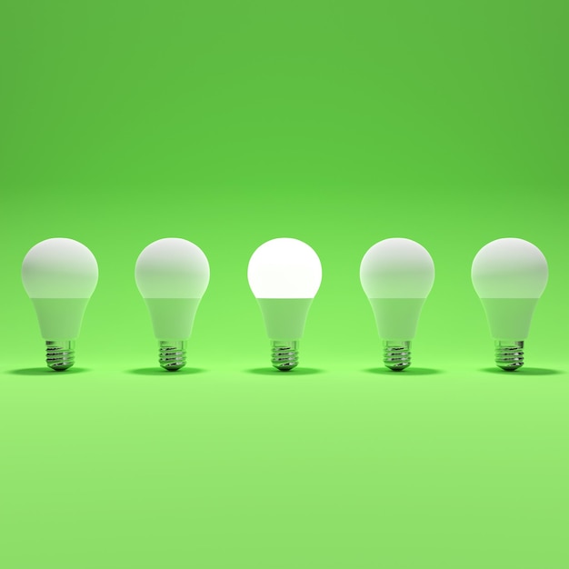 Five lightbulb and one glowing lightbulb with green background