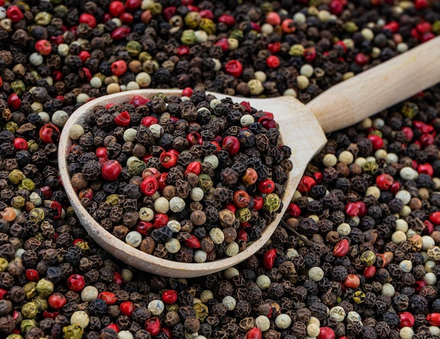 Five Peppercorn mix five varieties in a wooden spoon for a food background