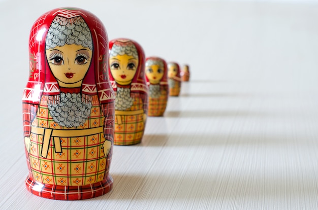 Five red matryoshka. Long shadows