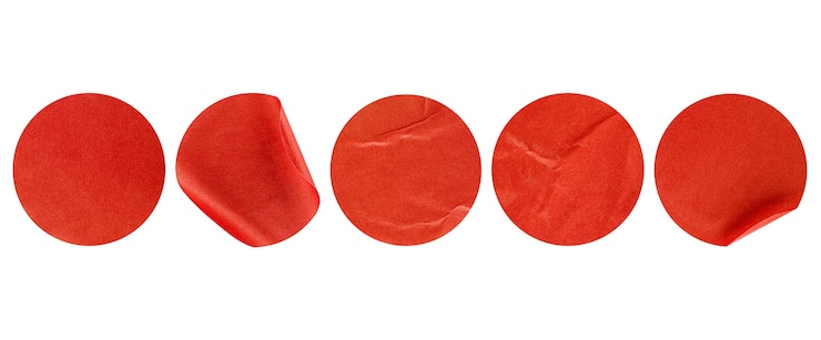 Photo five red round stickers on white isolated background