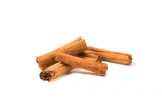 Five small fragrant cinnamon sticks overlapped with each other.