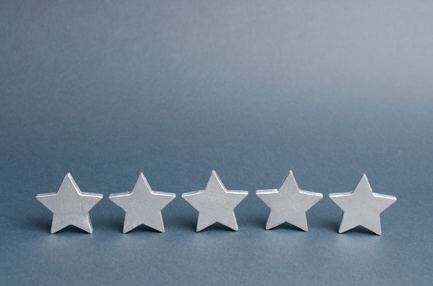 Five stars on a gray. Success in business. The concept of rating and evaluation