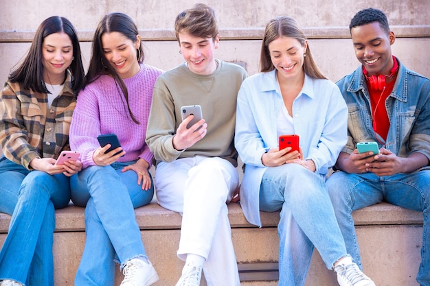 five students having fun with mobile phones creating content on social media