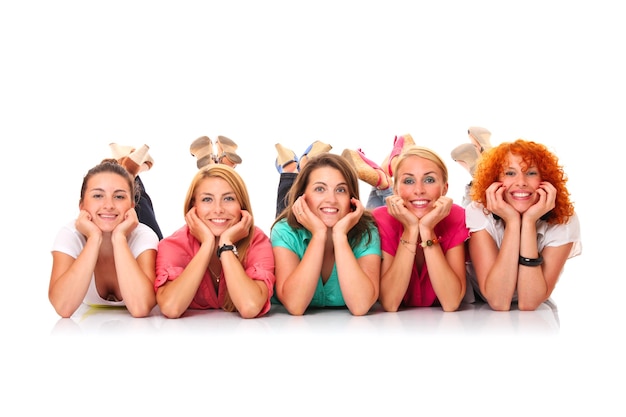 five women lying in a row and smiling over white