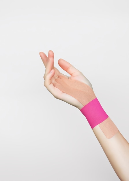 fixation of the wrist joint of a female hand with beige and pink kinesio tape