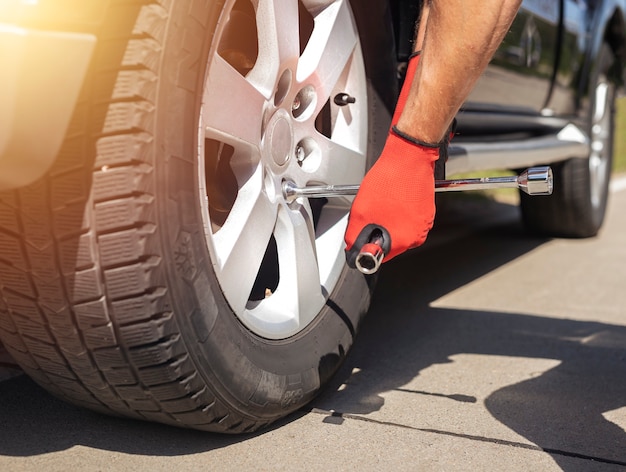 Fixing and checking wheel tyre of car with manual metal repair tool