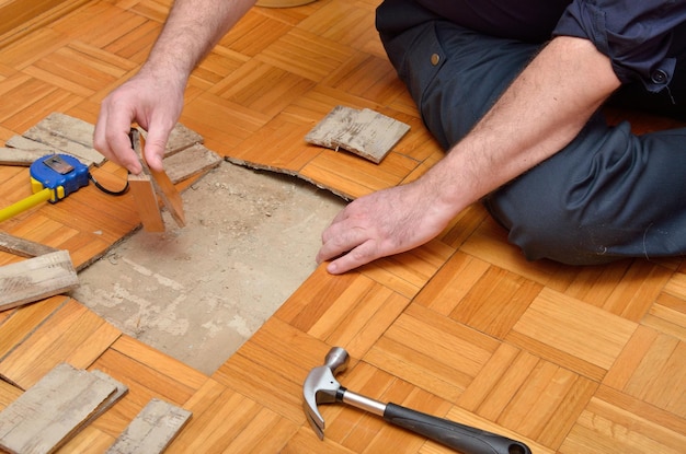 Photo fixing wooden parquet in the apartment damaged by moisture or water