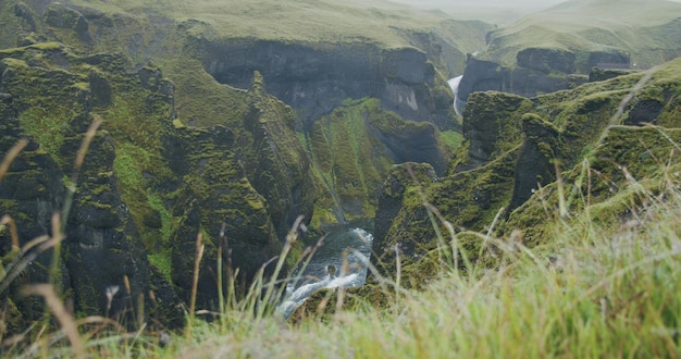 Fjadrargljufur canyon Bizarre steep cliff rock formations and winding river in the valley Iceland