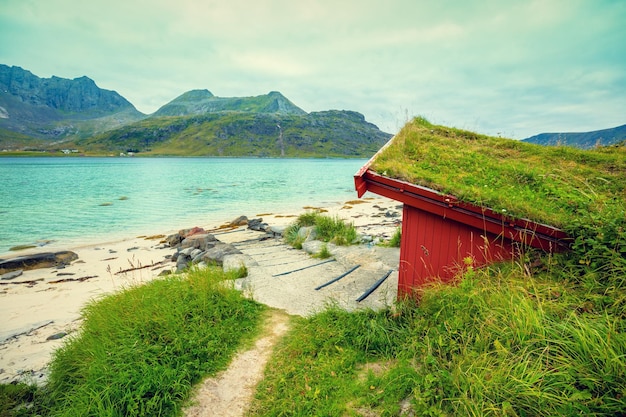 Fjord in rainy weather Fishing house on the beach Beautiful nature of Norway Lofoten islands