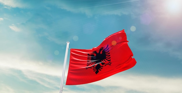 flag of albania waving in beautiful sky.