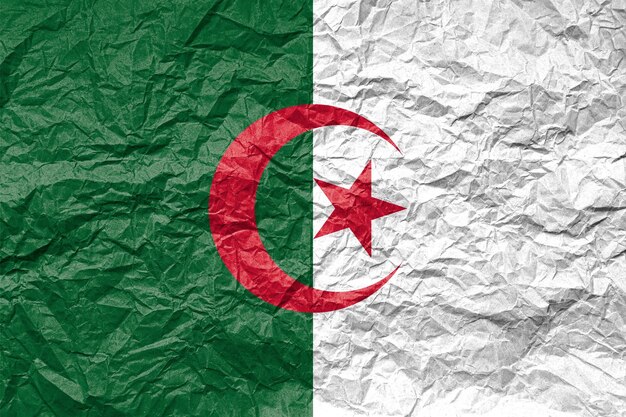 Flag of algeria on crumpled paper textured background