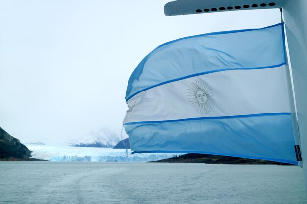 Flag of Argentina on a Cruise Ship Waving against Perito Moreno Glacier